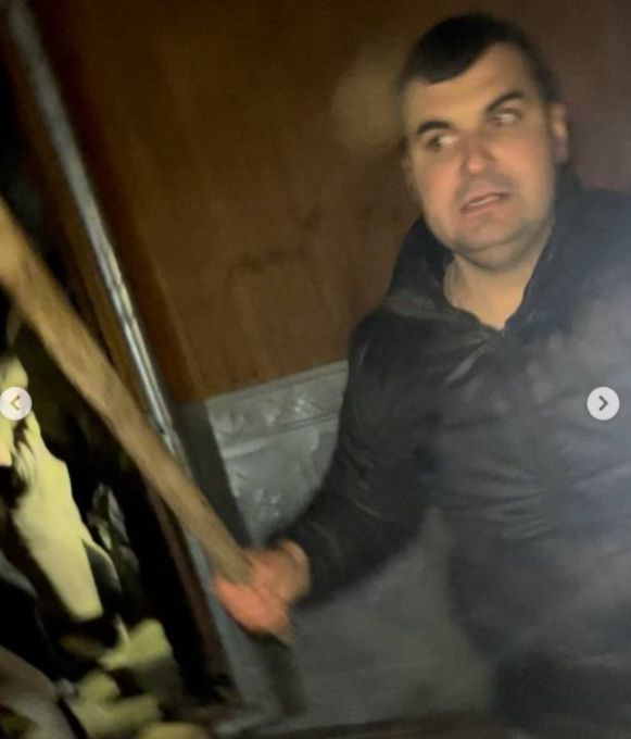 Обвинувачений Василь Гарбуз біля храму з палицею