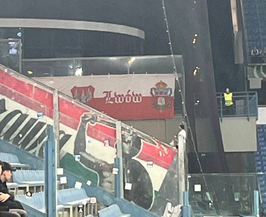 Слово «Львів» написане польською мовою так, як на картах 16-17 століття, коли Львів входив до складу Польщі. Також слово  «Львів» зображене на фоні польського прапора